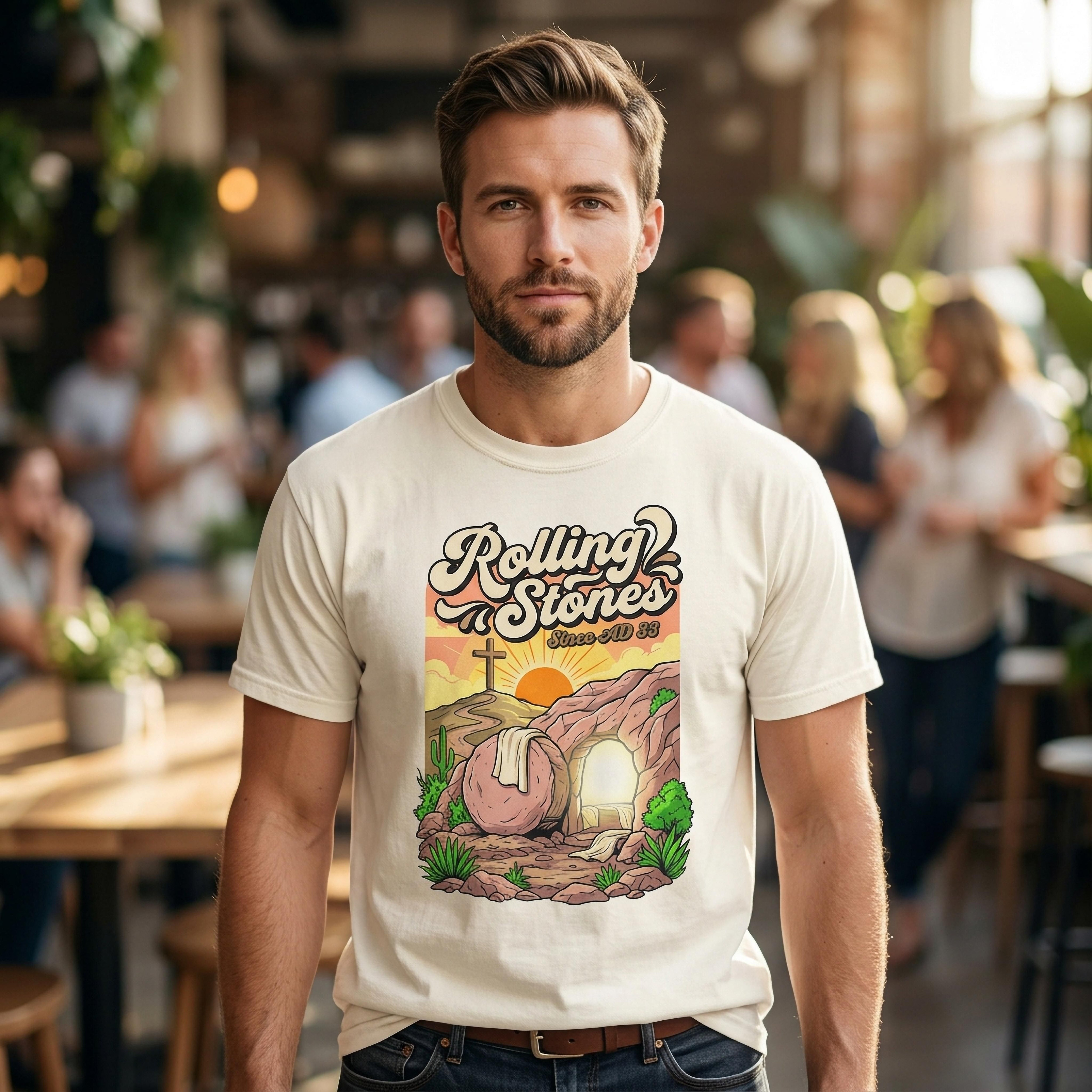 Cream t-shirt with "Rolling Stones Jesus Rolls The Stone Away" graphic.