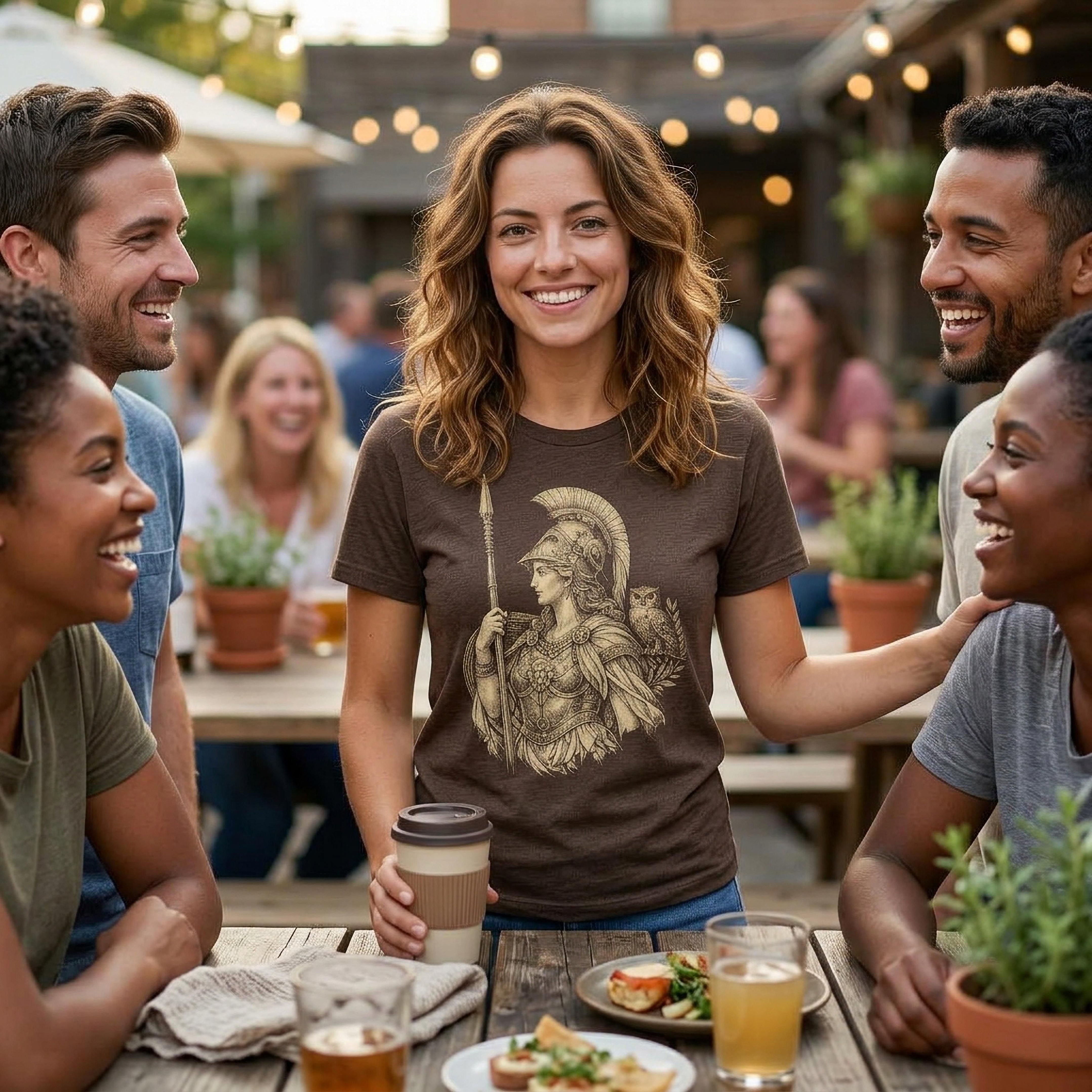 Woman wearing a graphic t-shirt with an illustration of Athena.