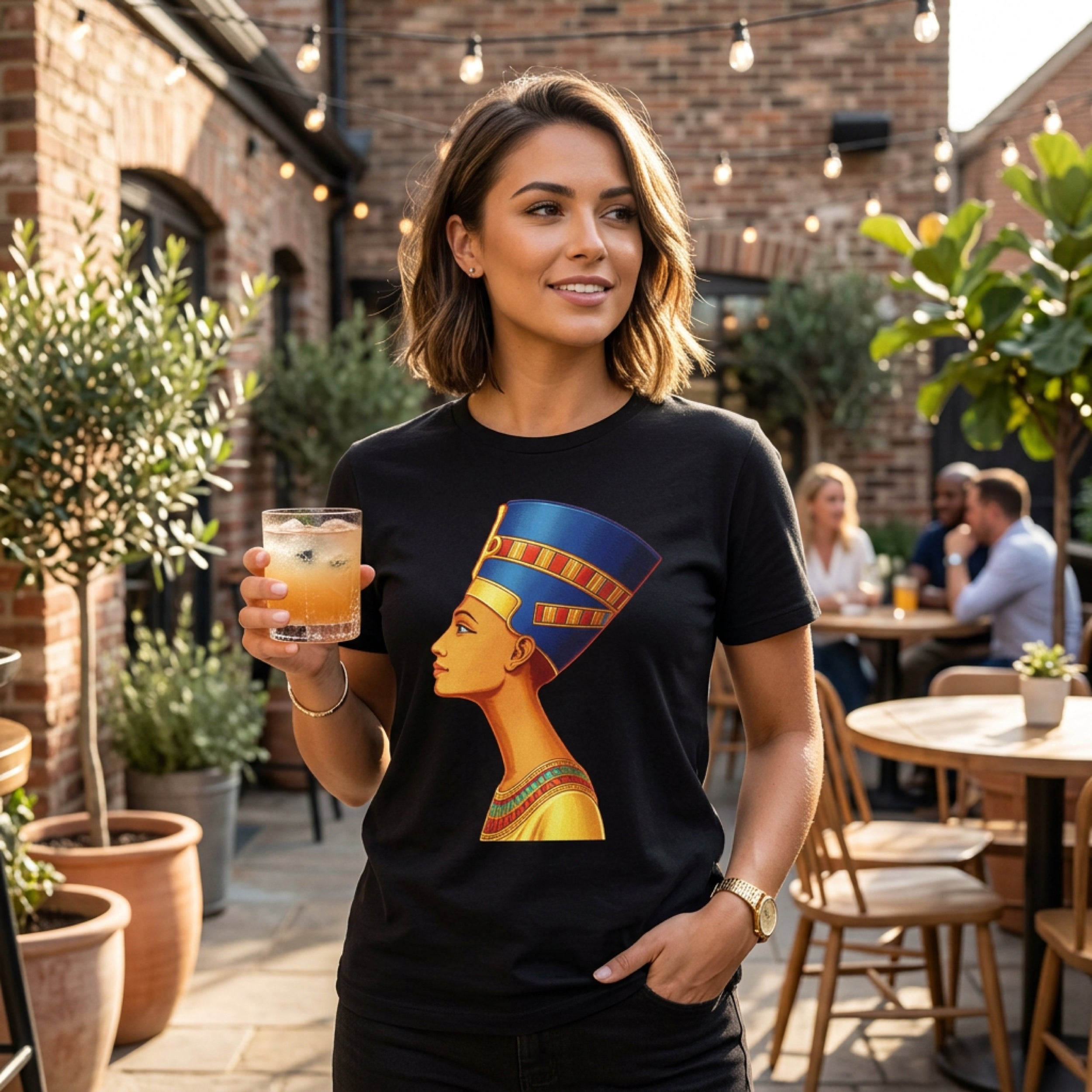 Woman wearing black t-shirt with Nefertiti profile graphic.