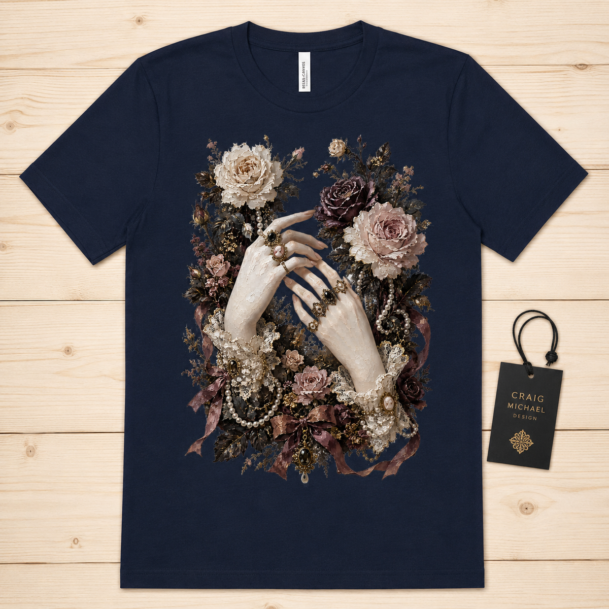 Navy t-shirt with ornate floral and hand graphic, featuring rings and pearls.