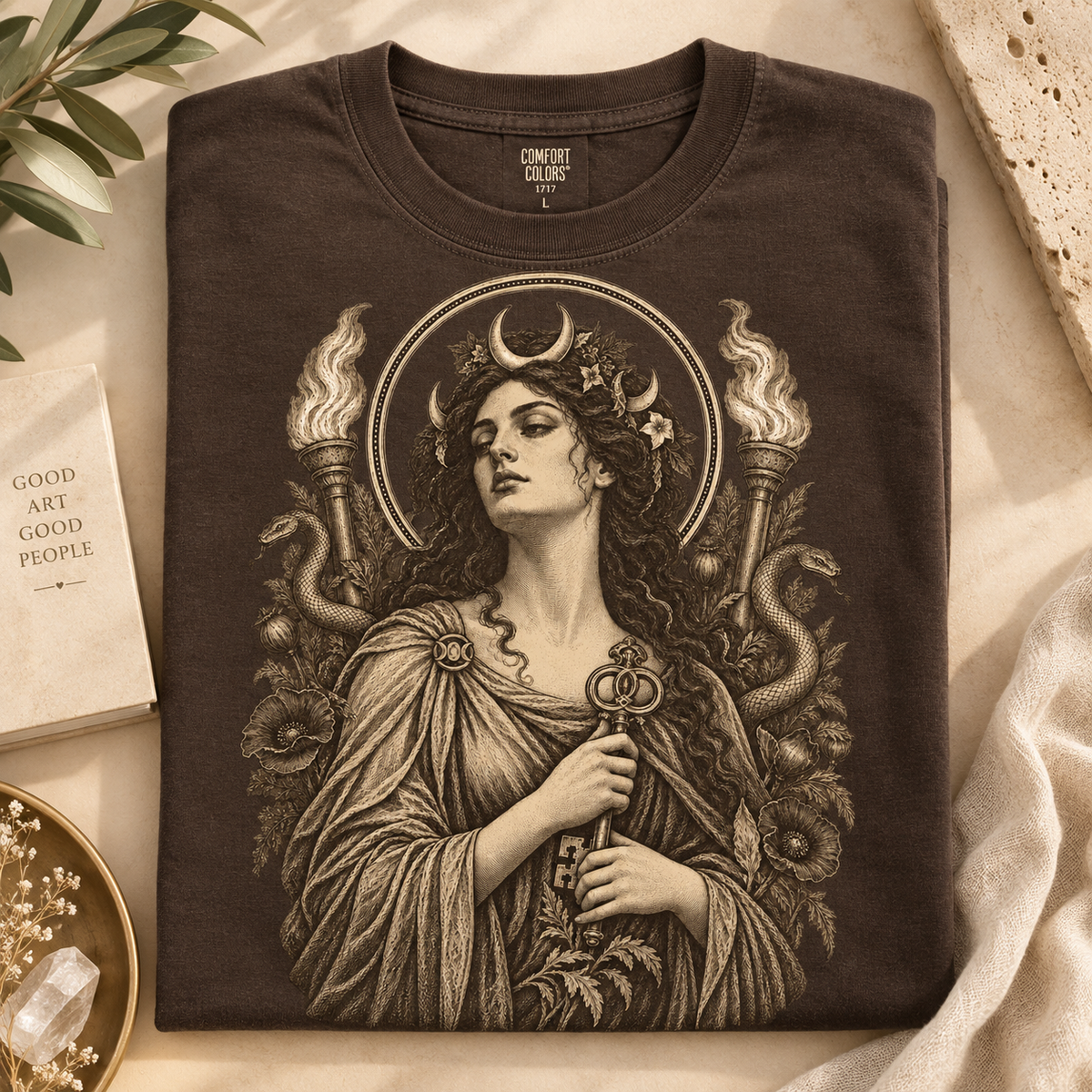 Brown t-shirt with vintage illustration of woman holding key, torches, and snakes.