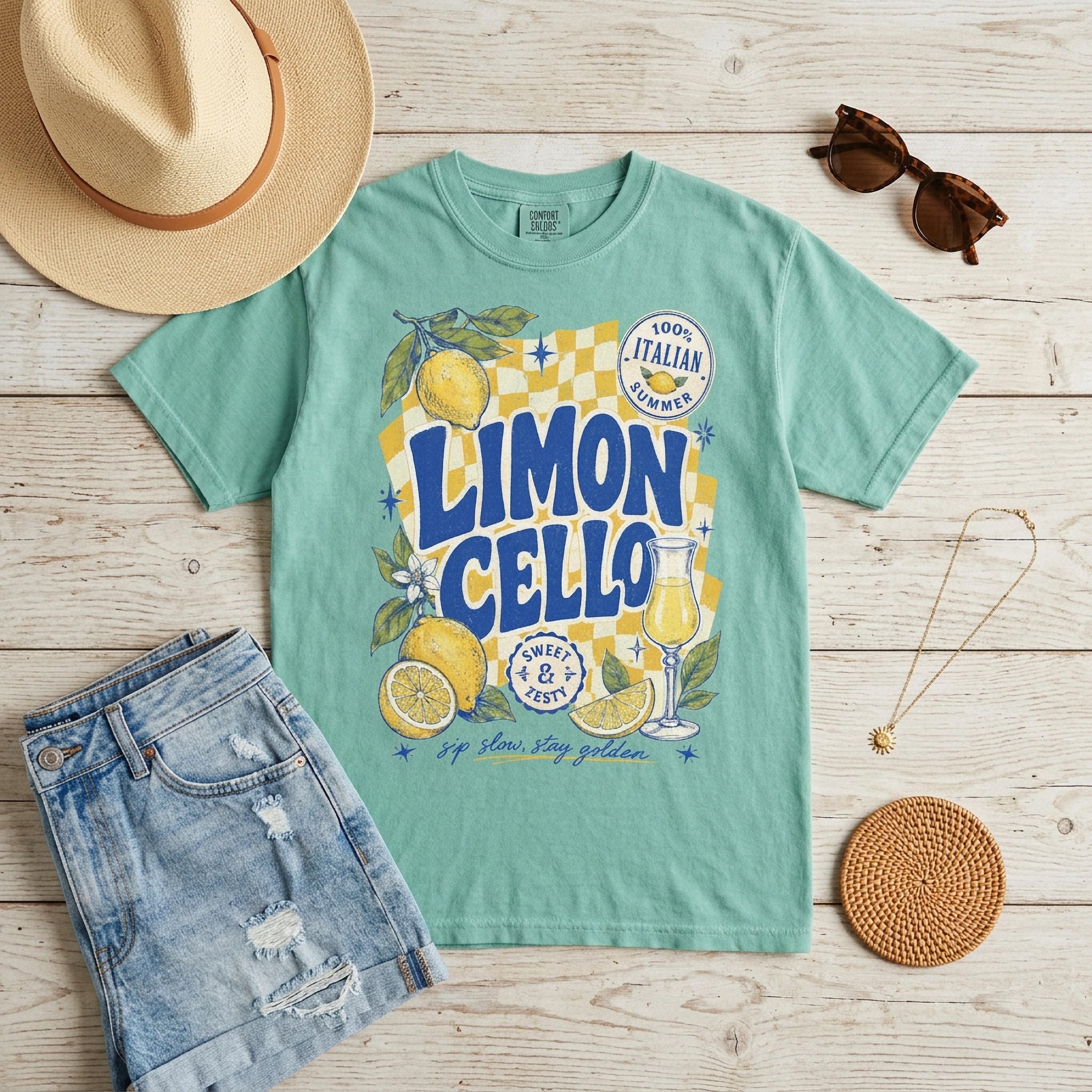 Teal t-shirt with "Limon Cello" text, lemons, and checkered pattern.